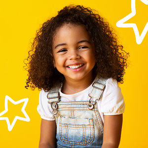 young girl wearing overalls